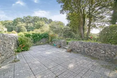 a stone wall next to a stone walkway at The Penthouse, top floor of a Grade II Listed Mill in Praze an Beeble