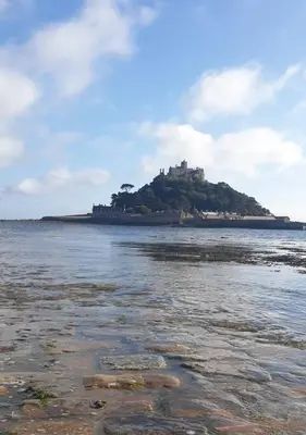 an island in the water with a castle on it at The Penthouse, top floor of a Grade II Listed Mill in Praze an Beeble