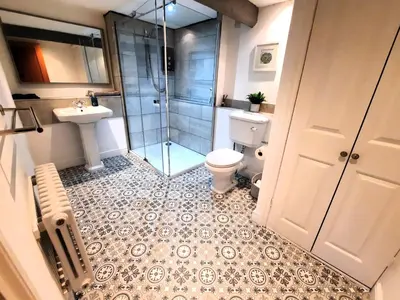 a bathroom with a shower and a toilet and a sink at The Penthouse, top floor of a Grade II Listed Mill in Praze an Beeble