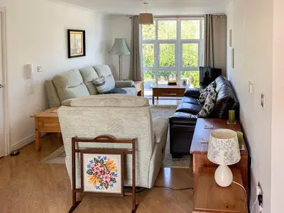 a living room with a couch and a table at Flat 18 Pochin House in St Austell