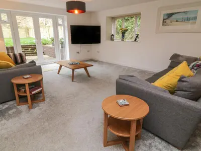 a living room with two couches and a tv at Brewers Cottage in Looe