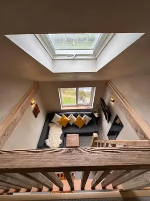 an attic view of a living room with a skylight at Sea View Nook in Porthtowan