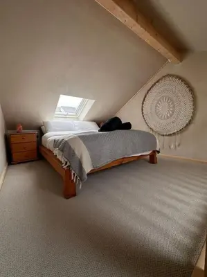 a bedroom with a large bed with a window at Sea View Nook in Porthtowan