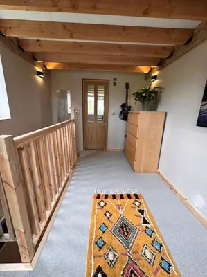 a room with a hallway with a rug on the floor at Sea View Nook in Porthtowan