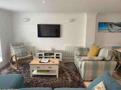 a living room with two couches and a tv at Surf's Up! Perfect base for holidays or work in Cornwall in Saint Columb Major