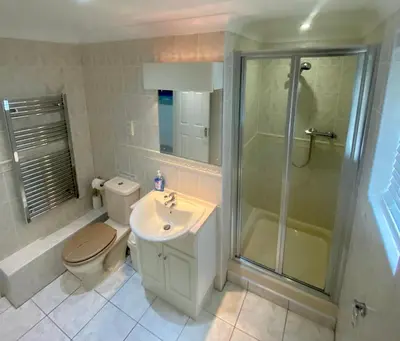 a bathroom with a toilet and a shower and a sink at Surf's Up! Perfect base for holidays or work in Cornwall in Saint Columb Major