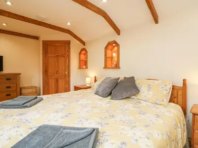 a bedroom with a large bed in a room at The Hideaway in St Austell
