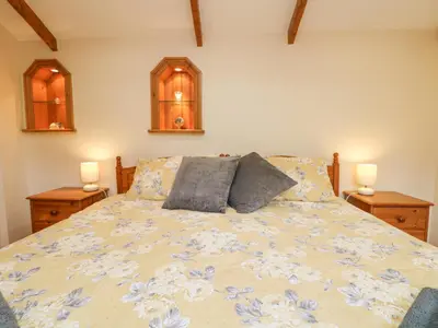 a bedroom with a bed with two pillows on it at The Hideaway in St Austell