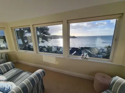 a living room with two couches and a view of the ocean at Lower Tresulian in Saint Mawes