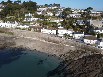 an aerial view of a coastal town with houses and water at Lower Tresulian in Saint Mawes