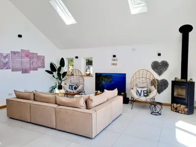 a living room with a couch and two chairs at 4 Bed Villa Sleeps 8 -Private Terrace-Free parking in St Austell