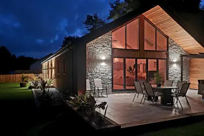 a house with a patio with a table and chairs at 4 Bed Villa Sleeps 8 -Private Terrace-Free parking in St Austell