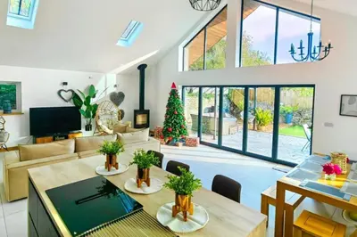 a living room with a christmas tree in it at 4 Bed Villa Sleeps 8 -Private Terrace-Free parking in St Austell