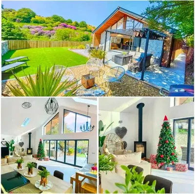 a house with a christmas tree in the yard at 4 Bed Villa Sleeps 8 -Private Terrace-Free parking in St Austell
