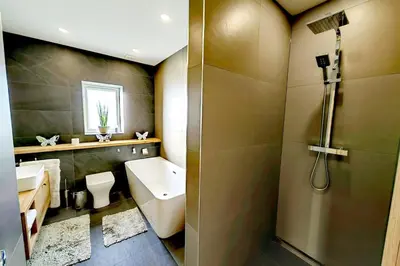 a bathroom with a toilet and a sink and a shower at 4 Bed Villa Sleeps 8 -Private Terrace-Free parking in St Austell