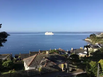 a cruise ship in the water with a house at Upper Tresulian in Saint Mawes