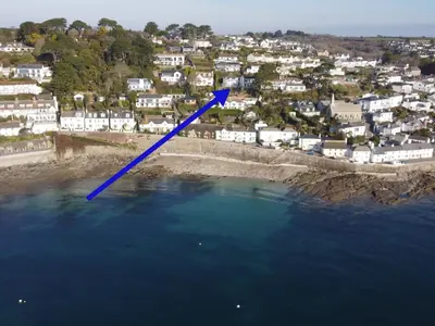 a blue arrow pointing into the water next to a beach at Upper Tresulian in Saint Mawes