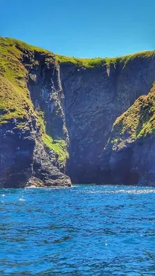 a view of a cliff from a boat in the water at Villa Sleeps 4 with Free Parking in Camelford
