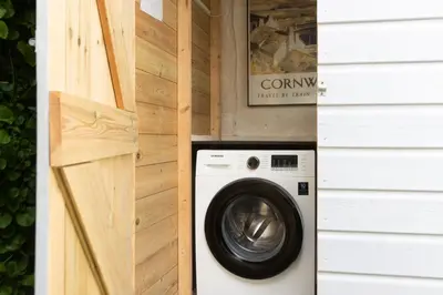 a washer and dryer in a tiny house at Saffron Cottage, St Ives in St Ives