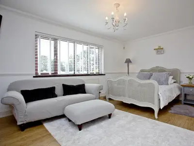 a living room with a couch and a chair at Hewas Water House in Grampound