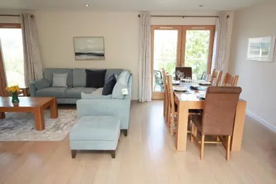 a living room with a table and a couch at House 10 in Looe