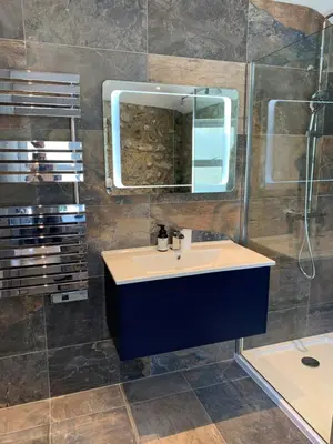 a bathroom with a sink and a mirror at Beach House Apartment 1 - St. Ives harbour front apartment with stunning views in St Ives