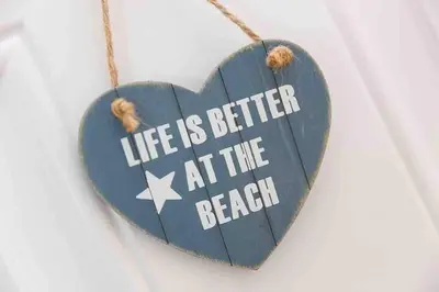 a heart shaped sign with the words life is better at the beach at Little Haven St Ives - with parking in St Ives