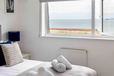 a bedroom with a window with a view of the ocean at Little Haven St Ives - with parking in St Ives
