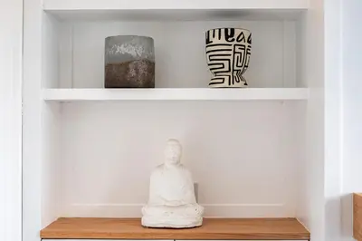 a shelf in a living room with sculptures on it at Seapinks in Port Isaac