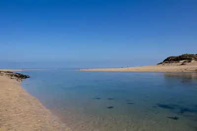 a body of water with a sandy beach at The Studio, Rosebud. 5 minutes walk to beach. in Uny Lelant