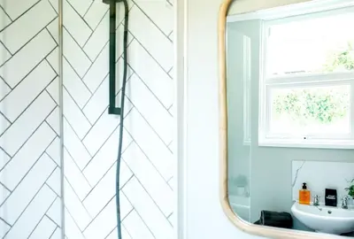 a bathroom with a sink and a mirror at Stylish cottage in the heart of town in Lostwithiel
