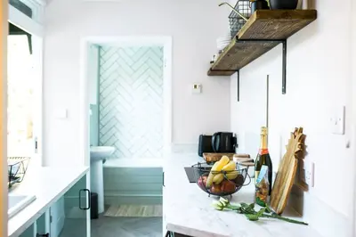 a kitchen with a counter with a bowl of fruit at Stylish cottage in the heart of town in Lostwithiel