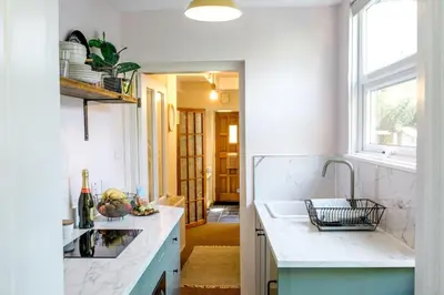 a kitchen with a sink and a counter top at Stylish cottage in the heart of town in Lostwithiel