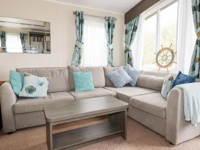 a living room with a brown couch with blue pillows at Lake View 10 in Par