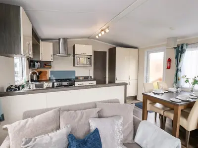 a living room and kitchen with a couch and a table at Lake View 10 in Par