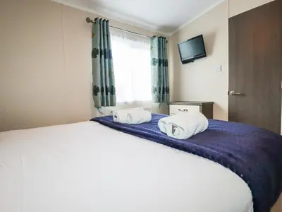 a bedroom with a bed with two towels on it at Lake View 10 in Par