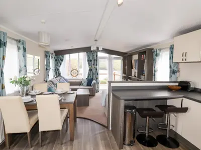 a kitchen and living room with a table and chairs at Lake View 10 in Par