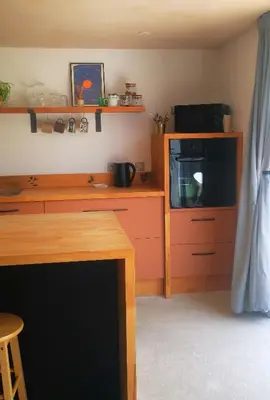 a living room with a tv and a counter with a tvictericter at Gwynn Lodge in Newquay