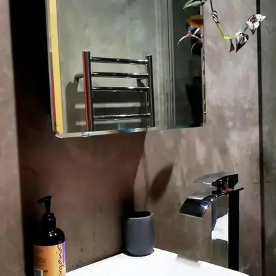 a bathroom sink with a mirror and a soap dispenser at Gwynn Lodge in Newquay