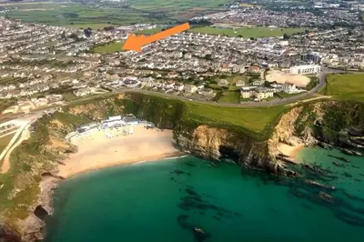 an aerial view of a beach with an orange arrow at Gwynn Lodge in Newquay