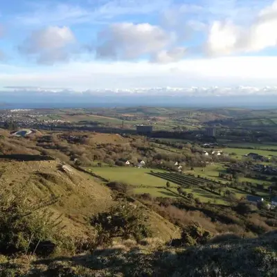 an aerial view of a green field on a hill at Home from Home self catering for 2 in St Austell