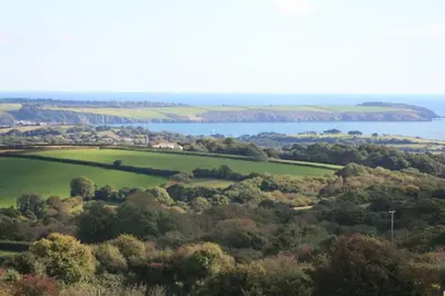 an aerial view of a green field and a body of water at Home from Home self catering for 2 in St Austell