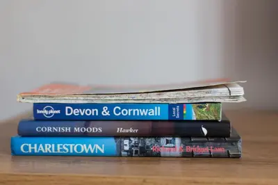 a stack of books sitting on a table at Home from Home self catering for 2 in St Austell
