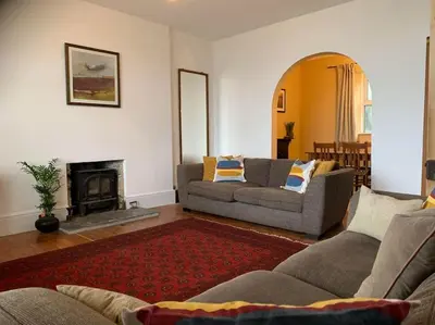 a living room with two couches and a fireplace at The Post House in Charlestown