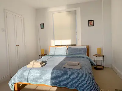 a bedroom with a bed with towels on it at The Post House in Charlestown