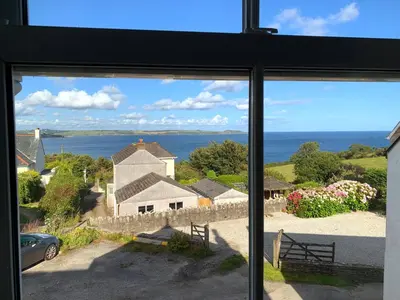 a window view of the ocean from a house at The Post House in Charlestown