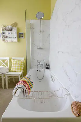 a white bath tub in a room with a chair at Trewardale in Bodmin