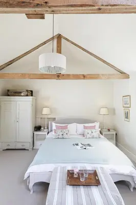 a white bedroom with a bed with a tray on it at Trewardale in Bodmin