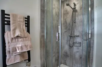 a bathroom with a shower with a glass door at Finest Retreats - Lesceave Cottage in Praa Sands