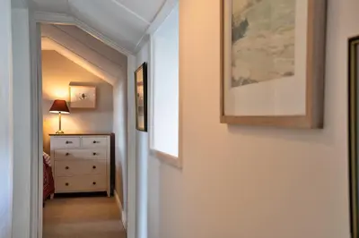 a hallway with a dresser and a picture on the wall at Finest Retreats - Lesceave Cottage in Praa Sands